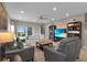 Cozy living room featuring two leather sofas, a ceiling fan, and entertainment center at 320 Primrose Dr, Davenport, FL 33837