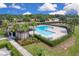 Overhead view of community pool offering a refreshing retreat, with palm trees and manicured landscaping at 320 Primrose Dr, Davenport, FL 33837