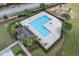 Bird's-eye view of a pool area and poolside lounge with palm trees, perfect for relaxation at 320 Primrose Dr, Davenport, FL 33837