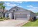 Charming two-story home with a gray exterior, a spacious garage, and well-maintained landscaping at 328 Appaloosa Ct, Sanford, FL 32773