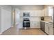 Well-lit kitchen with white cabinetry, tiled floors, and modern appliances, providing a functional and stylish cooking space at 328 Appaloosa Ct, Sanford, FL 32773