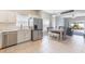 Bright kitchen featuring stainless steel appliances, granite countertops, and a dining area with ample seating at 328 Appaloosa Ct, Sanford, FL 32773