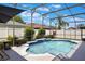 Screened-in pool with waterfall feature, surrounded by lush landscaping at 328 Appaloosa Ct, Sanford, FL 32773