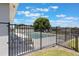 Community pool with black metal fence and lounge chairs, perfect for relaxing and enjoying sunny days at 328 Appaloosa Ct, Sanford, FL 32773
