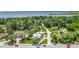 An aerial shot with a house marker nestled within lush trees, near a tranquil lake at 335 Debary Ave, Debary, FL 32713