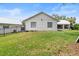 Spacious backyard featuring lush green lawn, fenced yard, and a white exterior at 335 Debary Ave, Debary, FL 32713