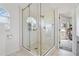 Bathroom with a glass shower, and arched window at 335 Debary Ave, Debary, FL 32713