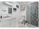 Bright bathroom featuring modern vanity, decorative wall art, and glass-enclosed tiled shower at 335 Debary Ave, Debary, FL 32713