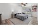 Bright bedroom featuring wood flooring, a gray patterned area rug, and a comfortable desk area at 335 Debary Ave, Debary, FL 32713