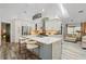 Bright kitchen with white cabinets, breakfast bar and stainless appliances open to the cozy living room at 335 Debary Ave, Debary, FL 32713