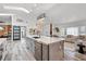 Spacious kitchen with large island featuring a unique pendant light, opening to a dining and living area at 335 Debary Ave, Debary, FL 32713