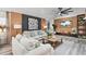 Cozy living room with wood-paneled accent wall, stylish furnishings, and a modern ceiling fan at 335 Debary Ave, Debary, FL 32713