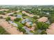A high angle of the community including pond, pool, mature landscaping, and nearby buildings at 3567 Shallot Dr # 103, Orlando, FL 32835