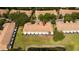 Aerial view of townhomes overlooking a lush green lawn and tranquil pond at 3567 Shallot Dr # 103, Orlando, FL 32835