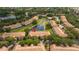 Aerial view of the community, showcasing lush landscaping, a pool, and a serene pond at 3567 Shallot Dr # 103, Orlando, FL 32835