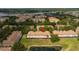 Aerial view of townhomes with a view of the lake in the background at 3567 Shallot Dr # 103, Orlando, FL 32835