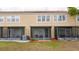 Rear view of a condo showing screened-in lanais and well-maintained landscaping at 3567 Shallot Dr # 103, Orlando, FL 32835