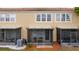 A view of the back of a condo with screened-in lanais and outdoor seating areas at 3567 Shallot Dr # 103, Orlando, FL 32835