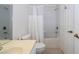 Bathroom featuring a shower/tub combo with white tiling and a white vanity at 3567 Shallot Dr # 103, Orlando, FL 32835