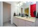 Bathroom features a dual sink vanity, toilet, and access to bedroom at 3567 Shallot Dr # 103, Orlando, FL 32835