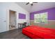 Bedroom featuring laminate floors, a desk, ensuite bathroom, and window view at 3567 Shallot Dr # 103, Orlando, FL 32835