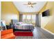 Bedroom features a ceiling fan, a queen bed, neutral linens and a wall mounted television at 3567 Shallot Dr # 103, Orlando, FL 32835