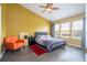 Bright bedroom with a queen-sized bed, orange chair, and natural light at 3567 Shallot Dr # 103, Orlando, FL 32835