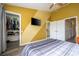 Bedroom featuring a walk-in closet, TV, and access to the bathroom at 3567 Shallot Dr # 103, Orlando, FL 32835