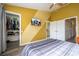 Bedroom featuring a walk-in closet, TV, and access to the bathroom at 3567 Shallot Dr # 103, Orlando, FL 32835