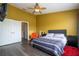 Bright bedroom with a queen-sized bed, orange chair, and access to ensuite at 3567 Shallot Dr # 103, Orlando, FL 32835