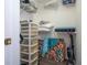 Walk in closet includes shelving, storage containers, vacuum cleaner, and artwork on the floor at 3567 Shallot Dr # 103, Orlando, FL 32835
