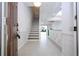 Light-filled entryway with tile floors and a staircase leading upstairs at 3567 Shallot Dr # 103, Orlando, FL 32835