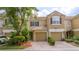 Charming townhome featuring a brick driveway, tile roof, and lush landscaping at 3567 Shallot Dr # 103, Orlando, FL 32835