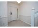 Clean, bright foyer with a white front door and paneled walls at 3567 Shallot Dr # 103, Orlando, FL 32835