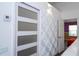 Upstairs hallway with wood floors, textured wall and view to the bedroom at 3567 Shallot Dr # 103, Orlando, FL 32835