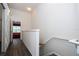 Upstairs hallway with wood floors, textured wall and view to the bedroom at 3567 Shallot Dr # 103, Orlando, FL 32835