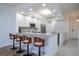 A bright kitchen with an island, stainless appliances, and bar seating at 3567 Shallot Dr # 103, Orlando, FL 32835
