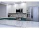 Close up of modern kitchen with stainless steel appliances and granite countertops at 3567 Shallot Dr # 103, Orlando, FL 32835