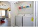 Convenient laundry room with modern washer and dryer set and shelving for storage and supplies at 3567 Shallot Dr # 103, Orlando, FL 32835