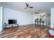 Bright living room with wood flooring and kitchen with bar seating at 3567 Shallot Dr # 103, Orlando, FL 32835