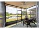 Enclosed patio overlooking the pond with seating for two at 3567 Shallot Dr # 103, Orlando, FL 32835