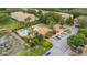 Aerial view of the community pool featuring lounge chairs, landscaping, and parking area at 3567 Shallot Dr # 103, Orlando, FL 32835