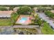 Aerial view of the community pool surrounded by landscaping and palm trees at 3567 Shallot Dr # 103, Orlando, FL 32835