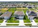Aerial view of a home with a well-manicured lawn, long driveway, and landscaping at 3829 Allegany Ln, Sanford, FL 32771
