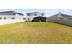 Spacious backyard with a white fence, a hot tub and a screen enclosure at 3829 Allegany Ln, Sanford, FL 32771