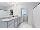 Bathroom featuring a double-sink vanity with granite countertops and a view of a walk-in closet at 3829 Allegany Ln, Sanford, FL 32771