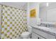 Well-lit bathroom featuring a sunflower shower curtain and granite countertop at 3829 Allegany Ln, Sanford, FL 32771