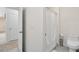 Well-lit bathroom featuring a shower with a white curtain and a toilet with convenient storage space at 3829 Allegany Ln, Sanford, FL 32771