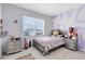 Stylish bedroom featuring a bed, matching nightstands, and modern purple wall accents at 3829 Allegany Ln, Sanford, FL 32771