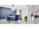 Dining room boasts modern decor, stylish mirror and blue accent wall at 3829 Allegany Ln, Sanford, FL 32771